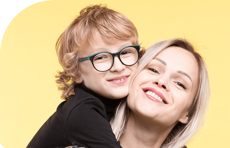 Child wearing glasses and mother smiling