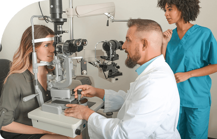 Doctor giving eye exam to female patient