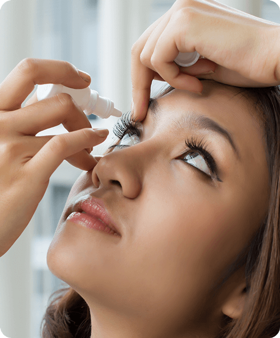Woman applying eye drops for pink eye