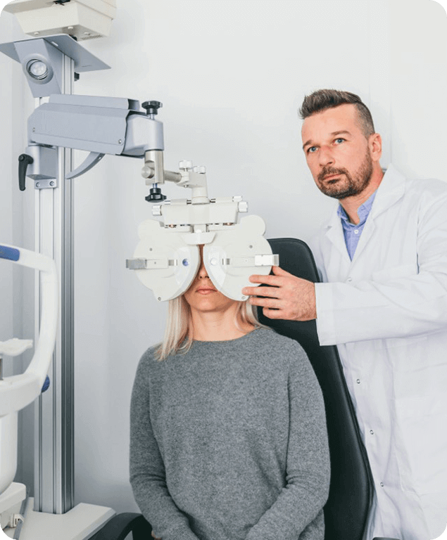 Doctor performing an eye exam for a female patient